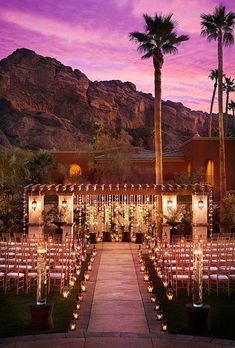 an image of a wedding venue with lights on the aisle and palm trees in the background