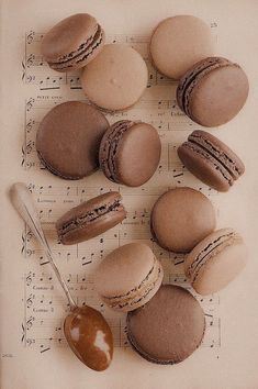 macaroons are arranged on top of sheet music