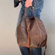 The bag is made of 100% genuine leather and 100% handmade. made of distressed real leather Wide:  38 cm tall : 32 cm deep:  12 cm strap: 104 cm  *Without lining * one zipped interior pocket. * two interior pockets. Distressed Brown Tote Shoulder Bag With Leather Handles, Distressed Brown Bags For Everyday Use, Rustic Leather Shoulder Bag With Leather Handles, Distressed Brown Leather Handle Tote Shoulder Bag, Distressed Brown Soft Leather Shoulder Bag For Daily Use, Distressed Brown Leather Shoulder Bag, Daily Use Distressed Brown Soft Leather Shoulder Bag, Handmade Leather Hobo Bag, Handmade Leather Hobo Bag For Shopping