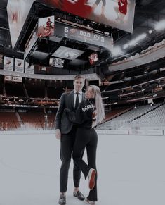 a man and woman standing on an ice rink