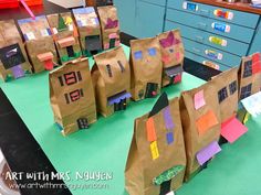 several brown paper bags sitting on top of a green table