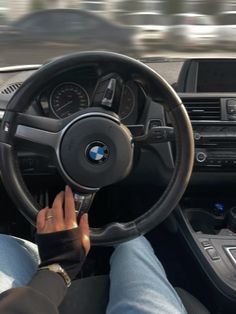 a person driving a car with their hands on the steering wheel