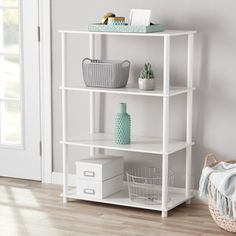 a white shelf with baskets on top of it in a room next to a door