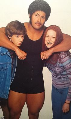 two women and a man are posing for a photo with their arms around each other