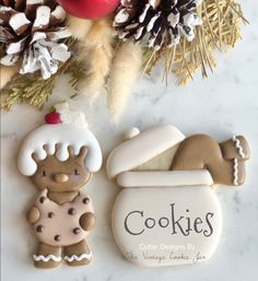 some cookies are laying on a table next to pine cones and other holiday decor items