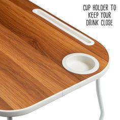 a close up of a wooden table with white legs and a cup holder to keep your drink close