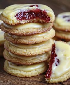 a stack of jelly filled cookies sitting on top of a wooden table