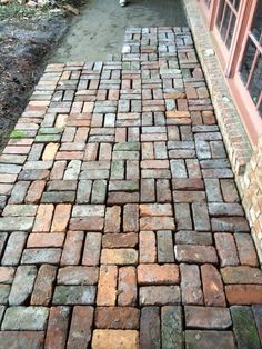 an old brick walkway is next to a building