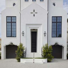 a large white house with black doors and windows