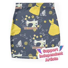 a skirt with yellow and grey sewing related images on the front, along with words support independent artists