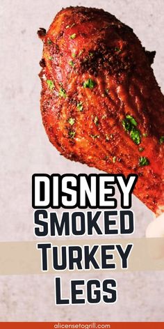 a hand holding up a piece of meat with the words disney smoked turkey legs