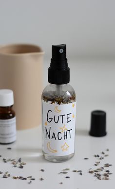 a bottle of glue nacht next to an empty container with some seeds on it