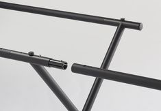 two metal tubes are attached to the back end of a bicycle frame with an extension bar