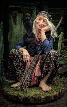 an old woman sitting on top of a stump with a cat in her lap next to her