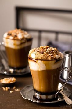 two cups filled with dessert sitting on top of a table