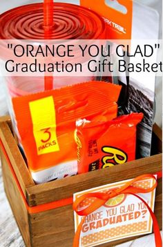 orange you glad graduation gift basket with candy and candies in it on a table