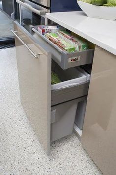 an open drawer in the middle of a kitchen