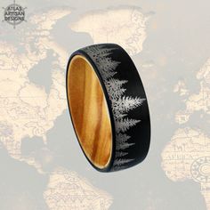 This 6mm unique nature wedding band has detailed spruce trees that accent the brushed black finish and exotic olive wood interior! The tungsten rings interior is lined with exotic olive wood for a . The smooth wood interior easily glides on your finger for a ring that has style without sacrificing comfort. The spruce tree accents within the brushed black tungsten are very detailed and etched throughout the wedding band. We are celebrating with a limited time sale and free delivery for your ring. Wedding Bands Couples, Nature Wedding Rings, Nature Wedding Band, Nature Wedding Ring, Black Tungsten Wedding Band, Spruce Trees, Wood Inlay Rings, Couples Wedding Bands, Unique Mens Rings