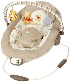 a baby swing with winnie the pooh on it's seat and remote control