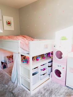 a child's bedroom with a bunk bed and toy washer machine in the corner