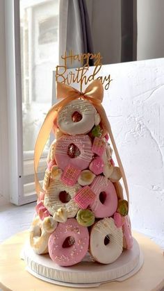 a birthday cake made to look like a doughnut tower