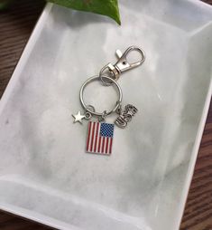 a silver keychain with an american flag on it