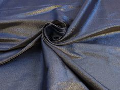 a close up shot of a blue fabric with metallic foil on the bottom and sides