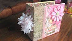 a pink and white paper bag sitting on top of a wooden table