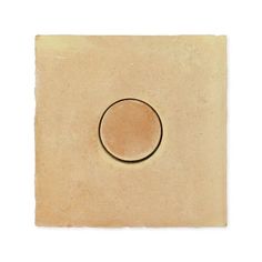 a square tile with a round hole in the middle