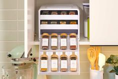 the spice rack in the kitchen is filled with spices and seasonings, along with utensils