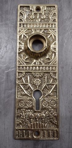 an antique brass door handle with ornate designs on the front and back panel, in various sizes