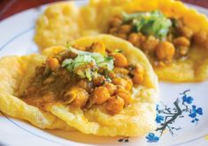 some food is on a white plate with blue flowers