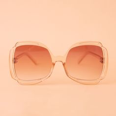 Add a touch of grooviness to your look with our Sofia Sunglasses in Champagne! These cute sunnies sport a playful clear and tan frame with a peachy gradient lens, making them a playful and eye-catching addition to any outfit. Chic Orange Sunglasses With Uv Protection, Clear Polarized Sunglasses For Spring, Trendy Clear Sunglasses With Tinted Lenses, Spring Clear Polarized Sunglasses, Trendy Clear Sunglasses For Spring, Trendy Clear Sunglasses With Gradient Lenses, Trendy Clear Sunglasses With Uv Protection, Trendy Clear Sunglasses For The Beach, Chic Clear Sunglasses For Spring