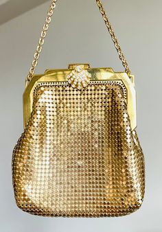 A very lovely and delicate vintage Whiting and Davis gold metal little purse.  Gold tone metal body, a gold chain and a gorgeous clasp with rhinestones makes this little purse a great accessory.  This bag is lined with golden satin.  Both bag and lining in great vintage condition.  The clasp is in great condition and all the stones are intact.  A great accessory for a special event or a bride.  Measurements With - 4" Height - 4 1/2 Drop - 3 1/2 My store strives for excellence, honesty and transparency.  Please ask questions and/or request additional photos, if needed, before making a purchase.     Please note: *Every item in my store is vintage used, unless stated in the description otherwise.     *My store does not accept returns.   *My store does not issue refunds, unless an item has not Vintage Gold Bags With Handwork, Vintage Gold Bags For Shopping, Vintage Gold Shoulder Bag For Shopping, Vintage Gold Handcrafted Bag, Compact Vintage Gold Coin Purse, Wedding Bags, Coin Purse Wallet, Metallic Purse, Wedding Bag