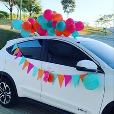 a car is decorated with balloons and streamers