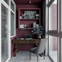 a desk with a laptop on top of it next to a window