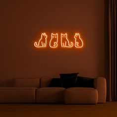 a living room filled with furniture and a neon sign on the wall that says cats