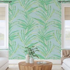 a living room scene with focus on the coffee table and green wallpaper behind it