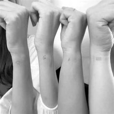 two girls with matching tattoos on their arms