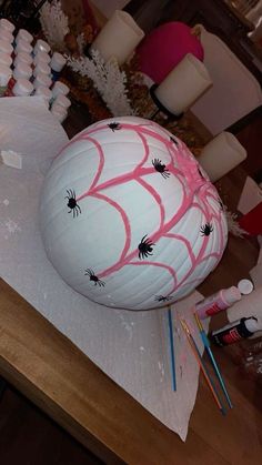 a large white ball with spider webs on it sitting on top of a table