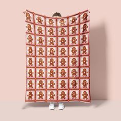 a red and white blanket with an image of a teddy bear on it