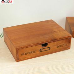 two wooden boxes sitting on top of a table next to each other with the words mercerie written on them