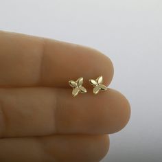 These are flower stud earrings, handmade of yellow 14k solid gold.  Their finish is shiny, and they are comfortable to wear. Small and dainty, these unique gold studs are perfect for everyday's wear.  Great as a gift as they can be enjoyed at any age and outfit. 14k solid gold ear backs are included. Size of the earrings is 5.3 x 5.8 mm = approx. 0.2 x 0.22 inch * The earrings will be packed in a gift box ready to give as a gift, and shipped via Express mail service which usually takes 4-6 business days to arrive. * For more gold earrings please click here:  https://www.etsy.com/shop/SigalGerson?section_id=13604349 To get back to my shop: http://www.etsy.com/shop/sigalgerson 14k Gold Flower Earrings For Gift, Dainty 14k Gold Flower Earrings For Anniversary, Dainty Yellow Gold Flower Earrings For Anniversary, Dainty Yellow Gold Flower Earrings For Gifts, Dainty Yellow Gold Pierced Flower Earrings, Hypoallergenic Yellow Gold Flower Earrings Gift, 14k Gold Flower Shaped Earrings For Gift, Dainty 14k Gold Pierced Flower Earrings, Yellow Gold Hallmarked Flower Earrings For Gift