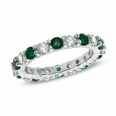 a white gold ring with emeralds and diamonds