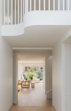 an open floor plan with white walls and wooden floors