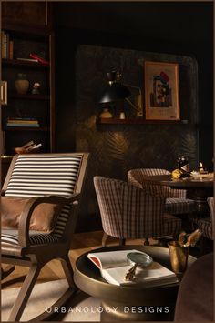 a living room filled with furniture next to a book shelf and lamp on top of a table