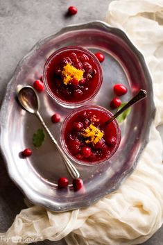 two glasses of cranberry sauce on a silver plate