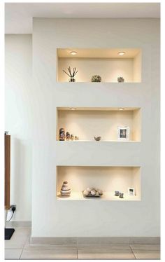 three white shelves with various items on them