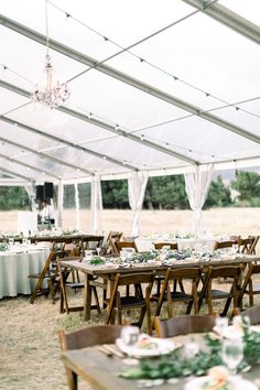 an outdoor tent with tables and chairs set up