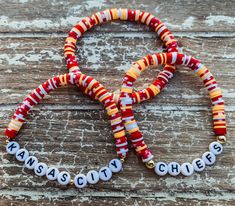 two bracelets with beads that say kansas city cheeses and the word kansas on them